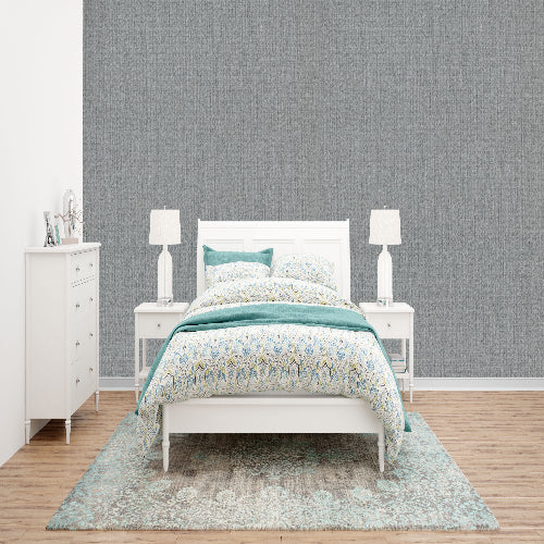 Bedroom with white bed, nightstands, and dresser against a gray wall.