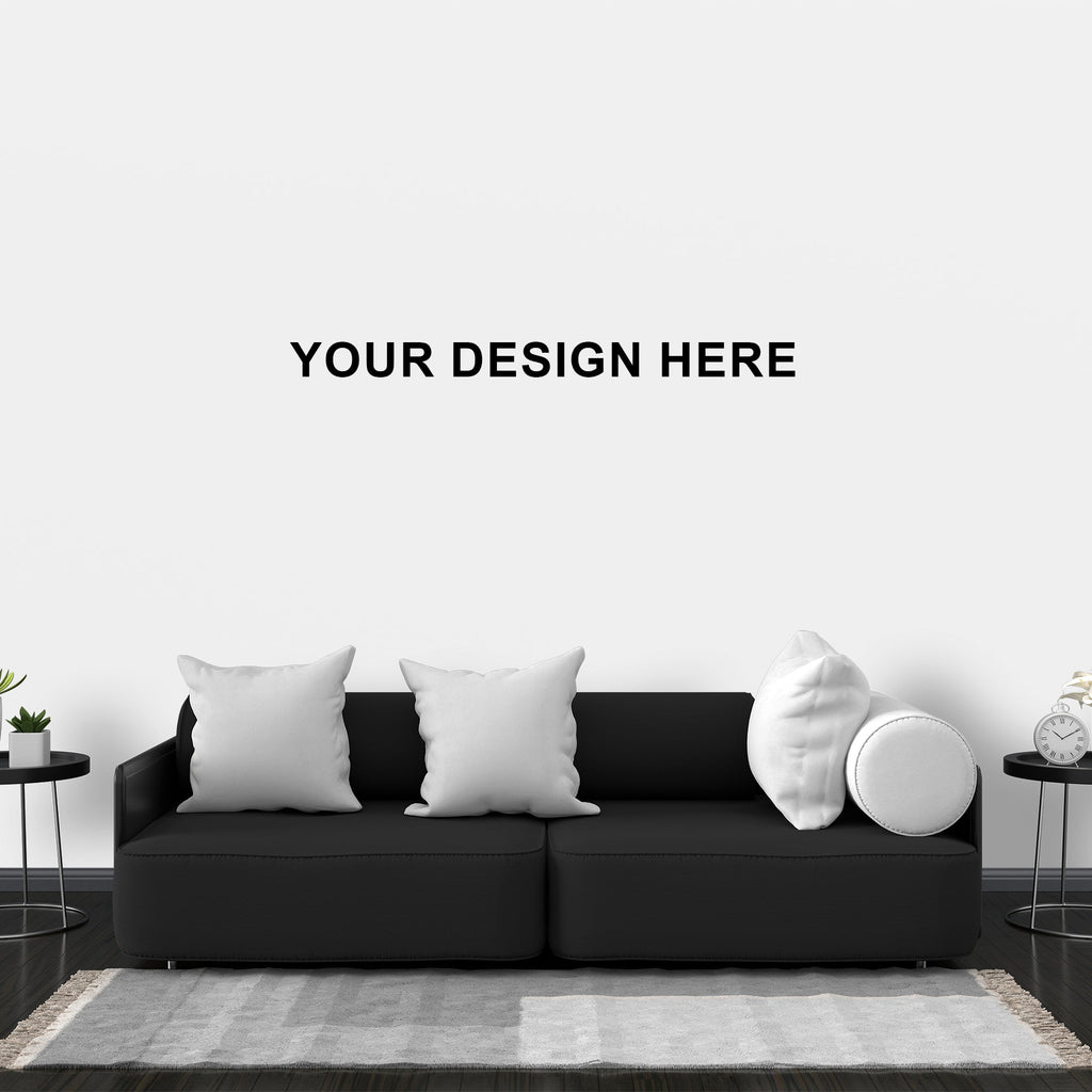 Black sofa with decorative pillows in a minimalistic living room setting