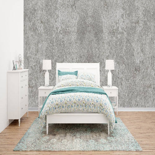 Bedroom with white furniture, including a bed, nightstands, and dresser, against a textured gray wall.