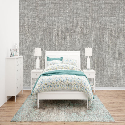 Bedroom with a bed, nightstands, and dresser against a textured wall.