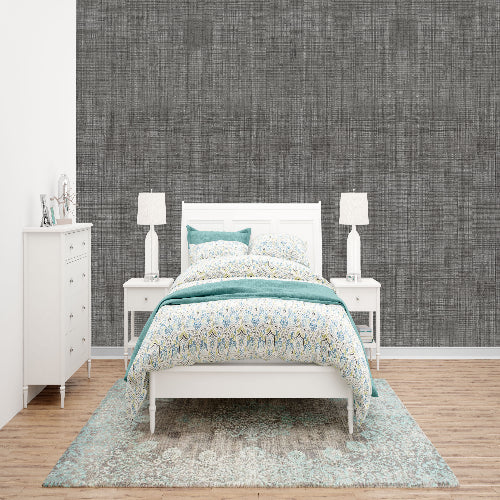 Bedroom with a bed, nightstands, and dresser against a textured gray wall.