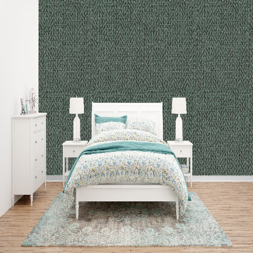 Bedroom with green patterned wallpaper, white furniture, and a floral comforter.