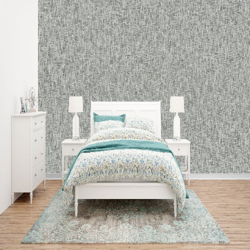 Bedroom with a white bed, nightstands, and dresser against a gray wall.