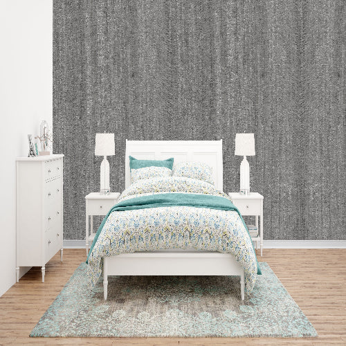 Bedroom with a bed, nightstands, and dresser against a textured gray wall.