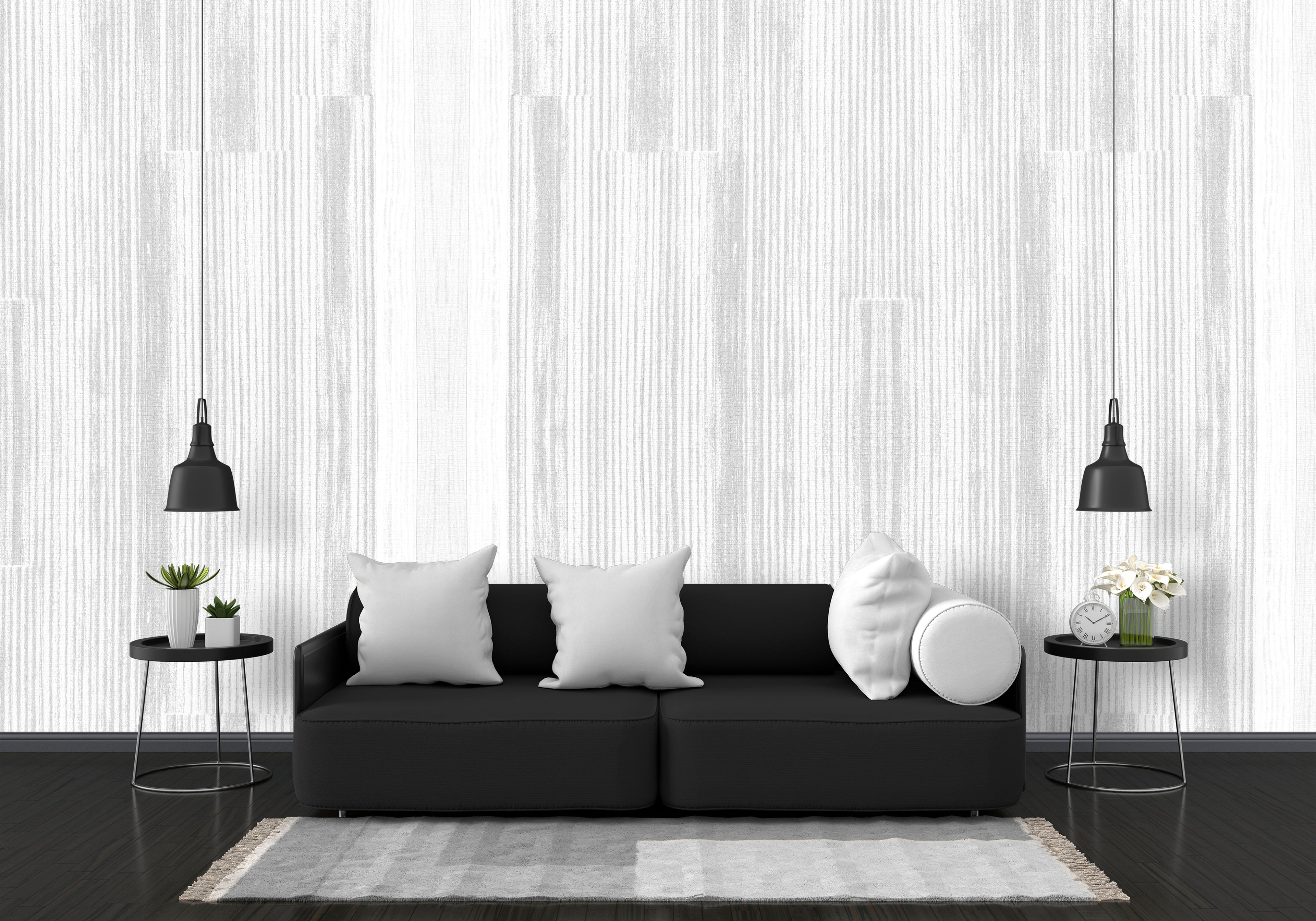 Modern living room with a black sofa, white cushions, and decorative items against a striped wall.