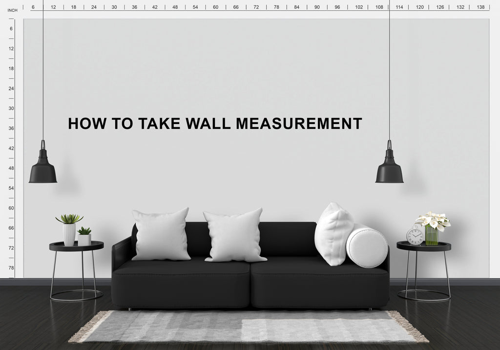 Modern living room with a black sofa, white walls, and decorative elements.