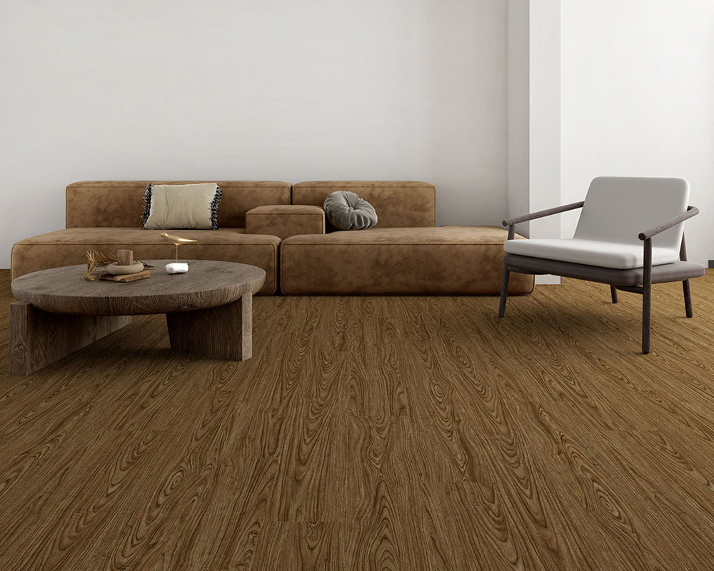 Modern living room with brown sectional sofa, round wooden coffee table, and gray armchair.