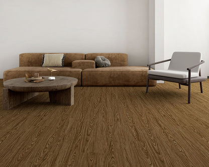 Modern living room with brown sectional sofa, round wooden coffee table, and gray armchair.
