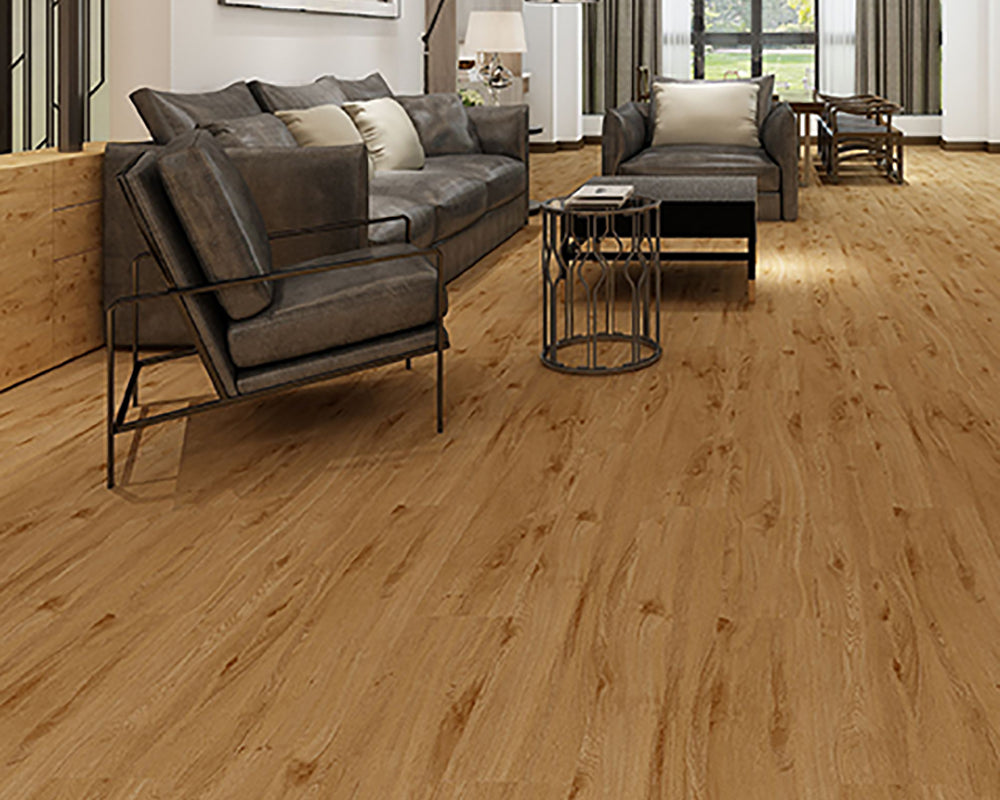 Living room with gray sofa, armchair, and coffee table on a wooden floor.