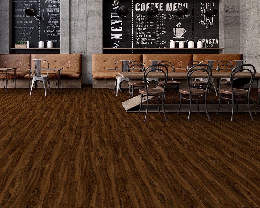 Restaurant interior with wooden floor, tables, chairs, and chalkboard menus.