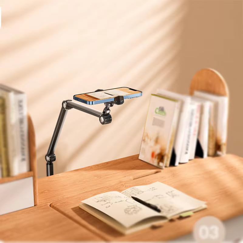 Desk setup with a smartphone on a flexible stand, notebook, and pen on a wooden desk.