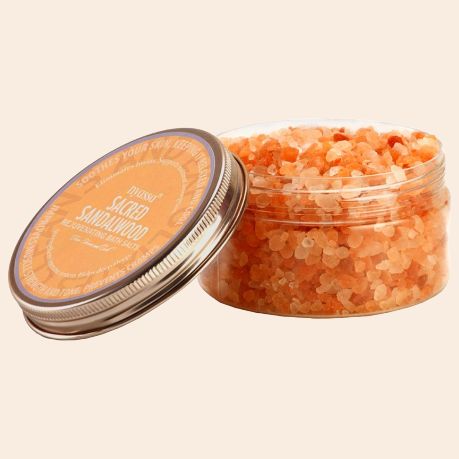 Jar of orange bath salts with a decorative label on a beige background