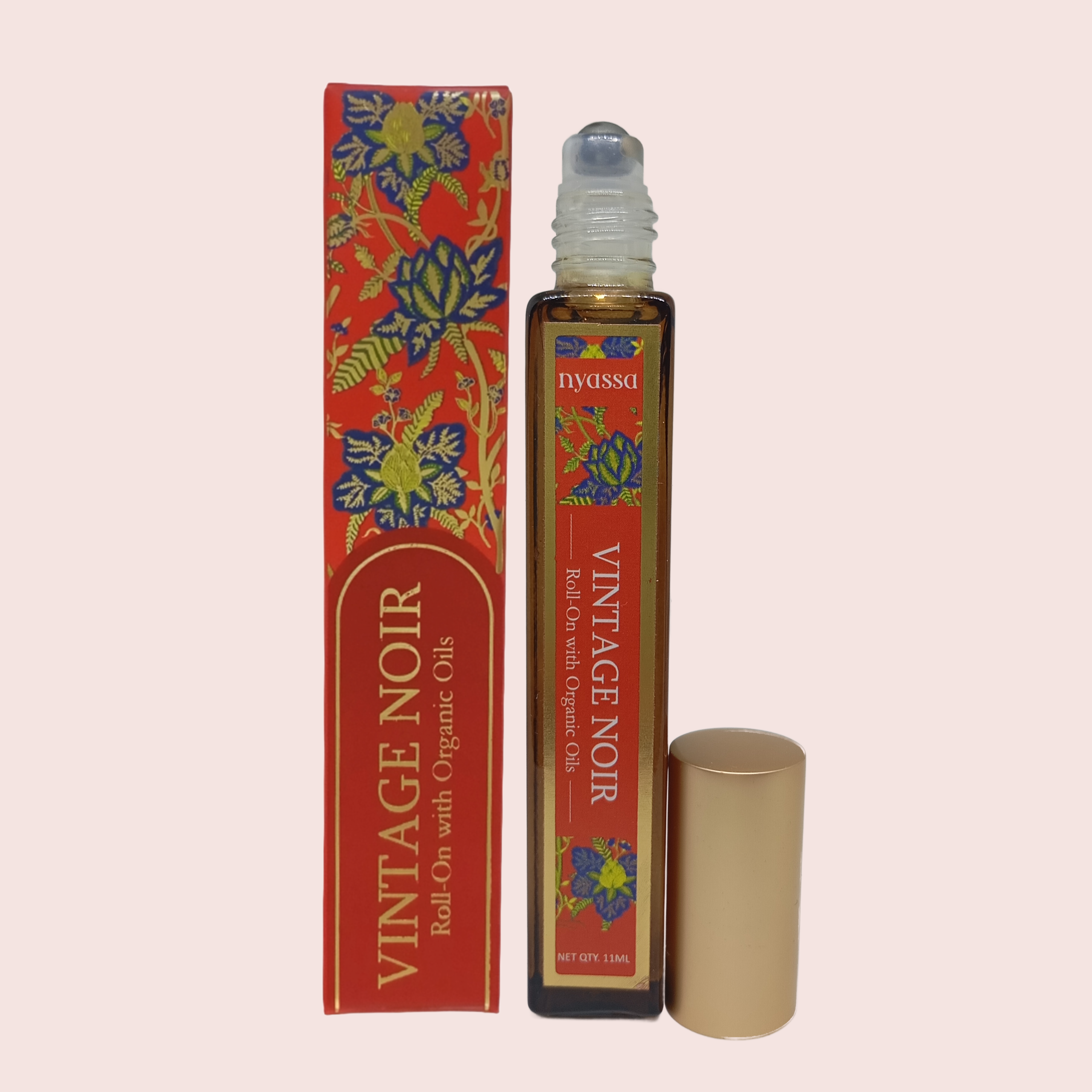 Roll-on bottle and box of Nyussa Vintage Noir with colorful floral design on a beige background