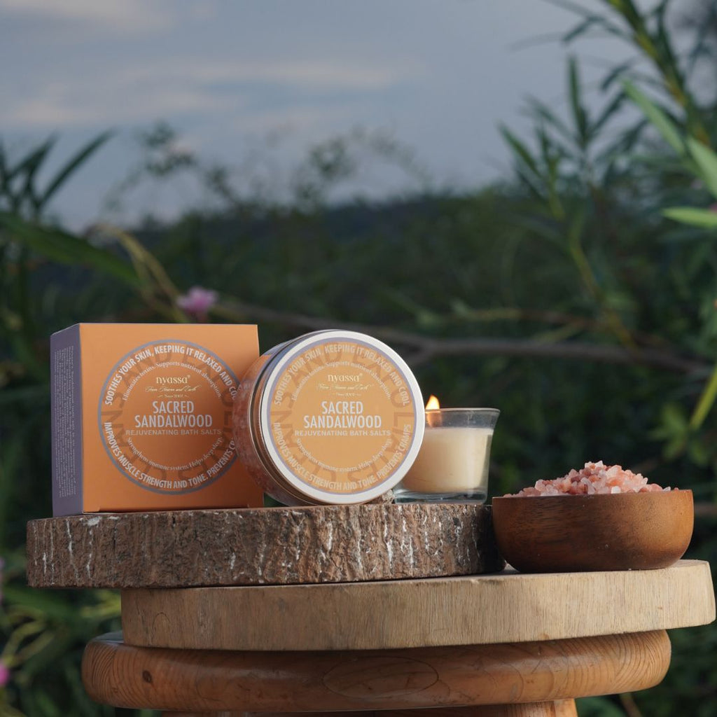 Candle and packaging on a wooden surface with a natural background