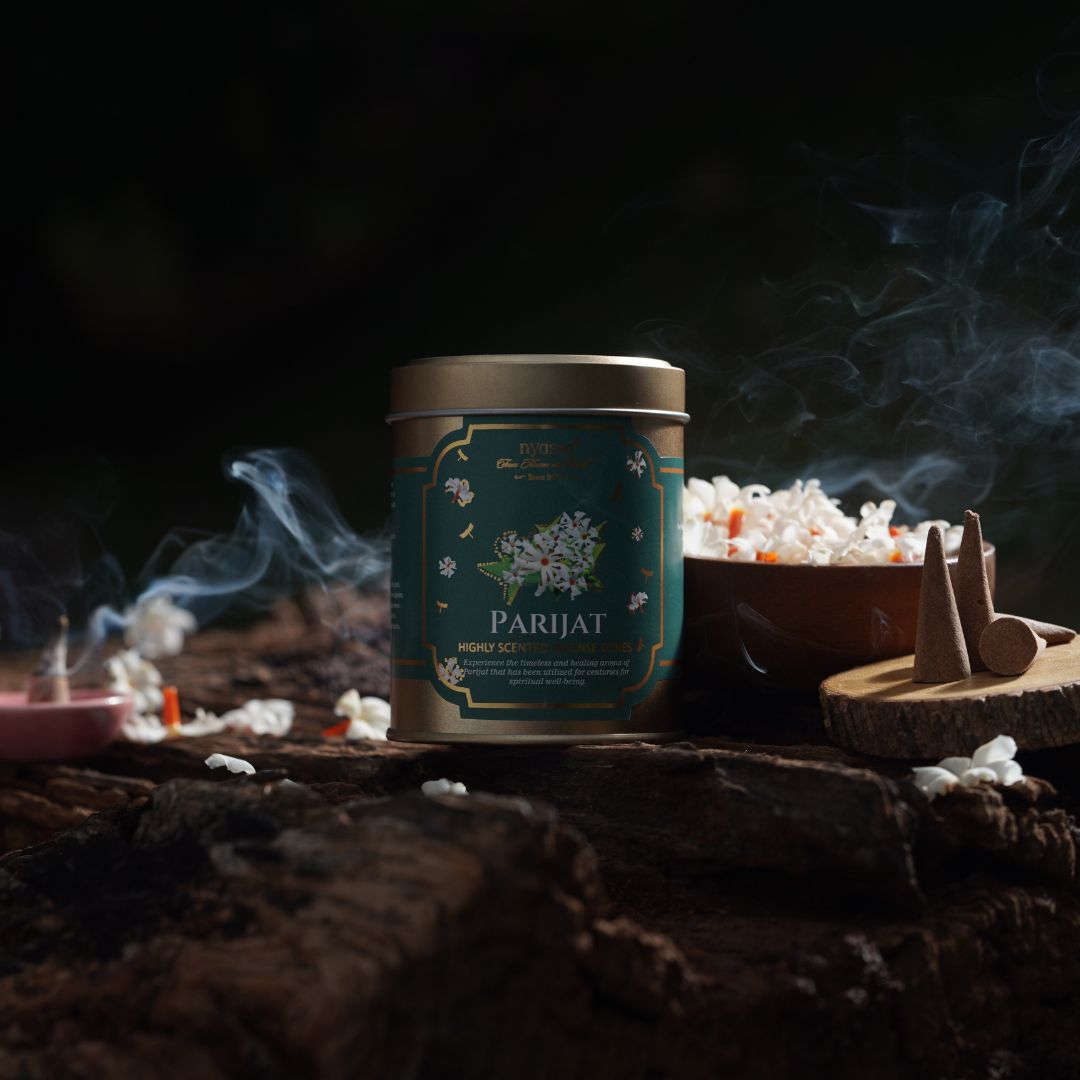 Parijat incense stick container with smoke and incense cones on a dark background