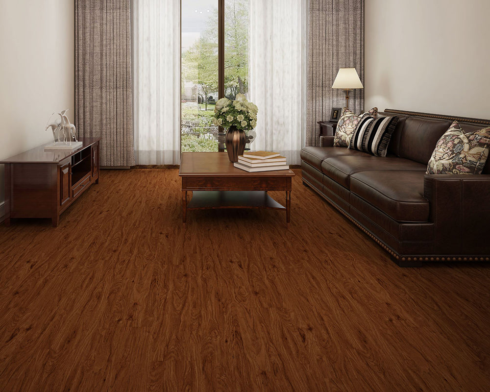 Living room with brown leather sofa, wooden coffee table, and large windows.
