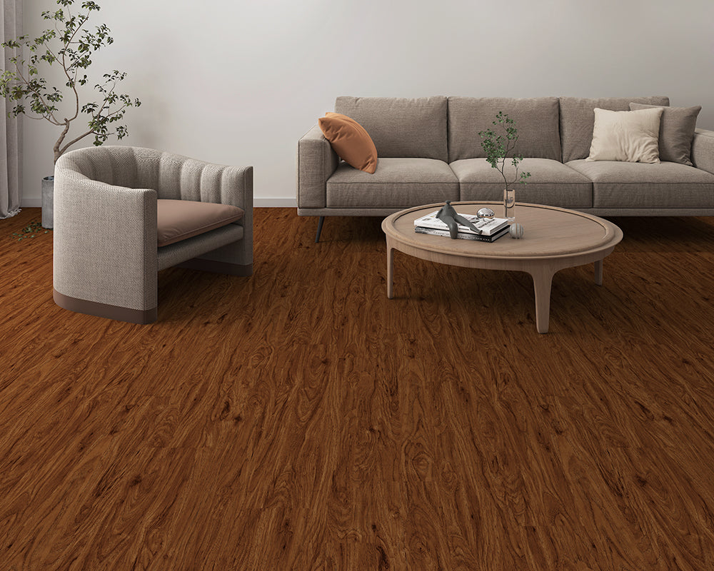 Modern living room with a gray sofa, armchair, and round coffee table on wooden flooring.