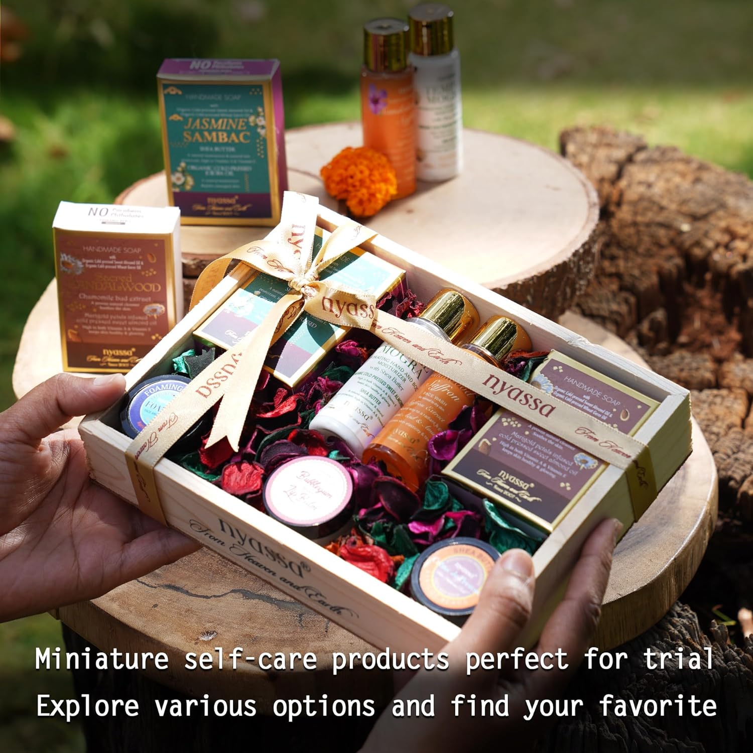 Miniature self-care products in a box held by hands with a natural background