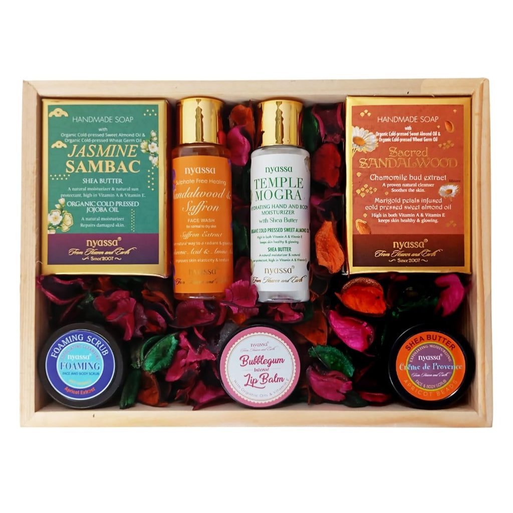 Nyassa skincare and wellness product set with various items in a wooden box.
