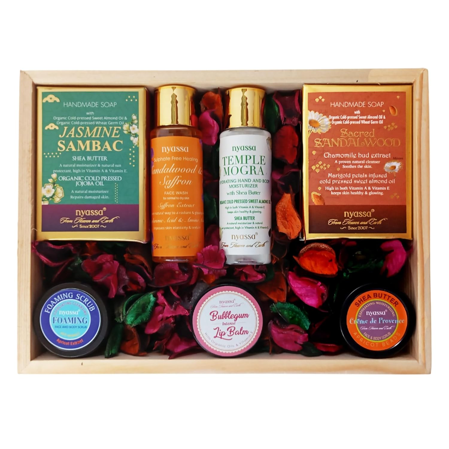 Nyassa skincare and wellness product set with various items in a wooden box.