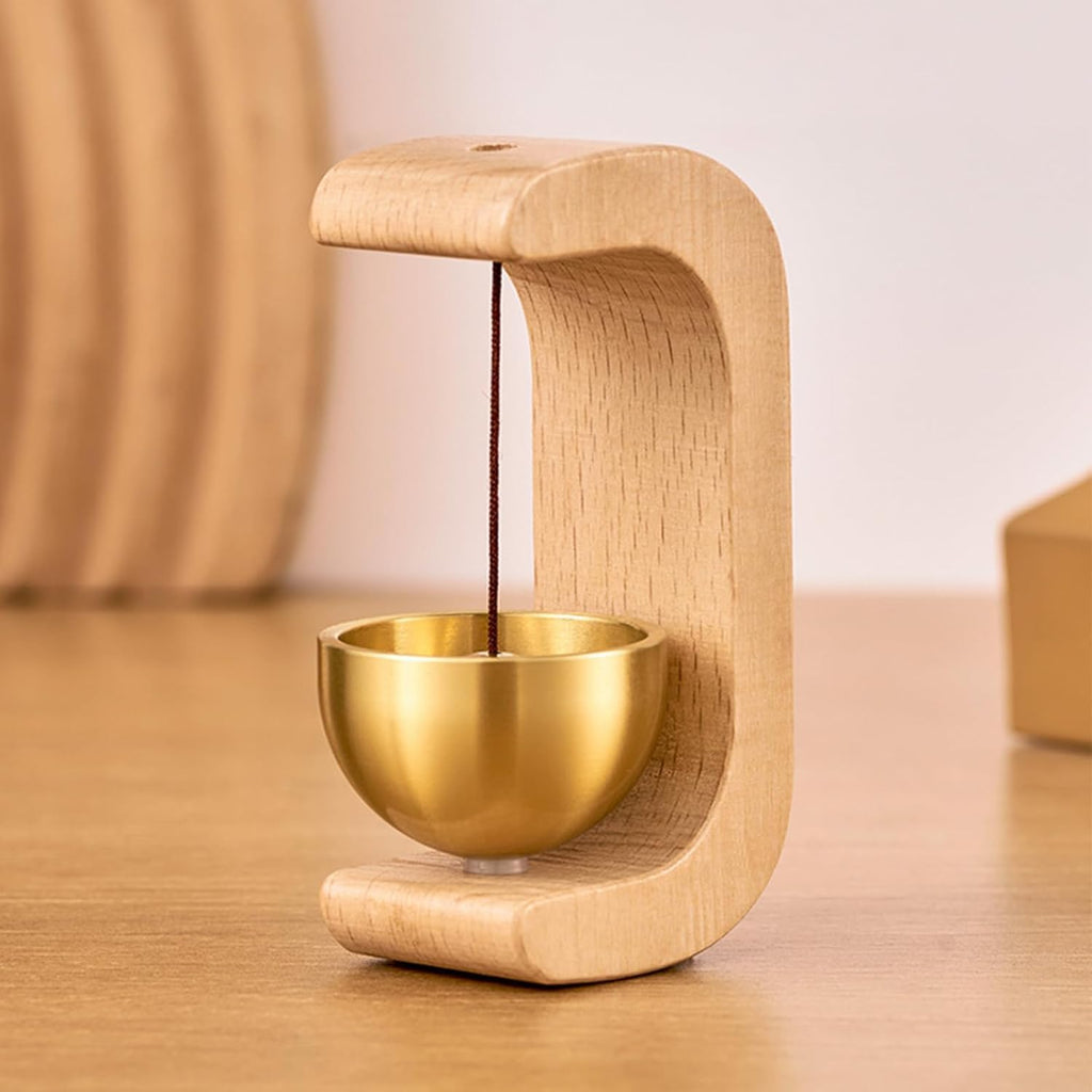 Wooden holder with a gold bowl on a wooden surface