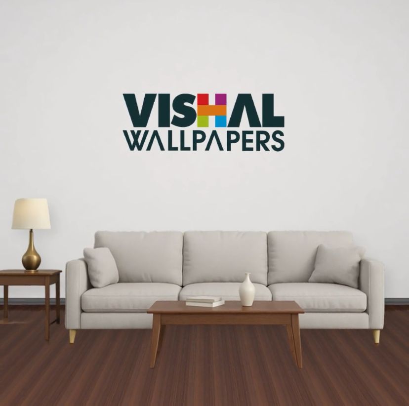 Living room with a gray sofa, wooden coffee table, and lamp, featuring Vishal Wallpapers logo.